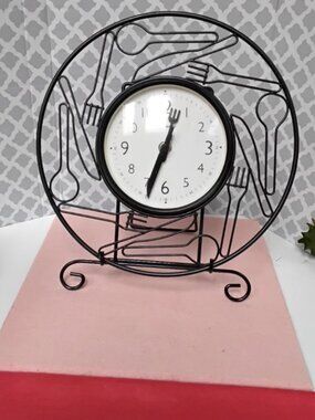 Black vintage-style metal kitchen clock open-wire frame Styled with utensils